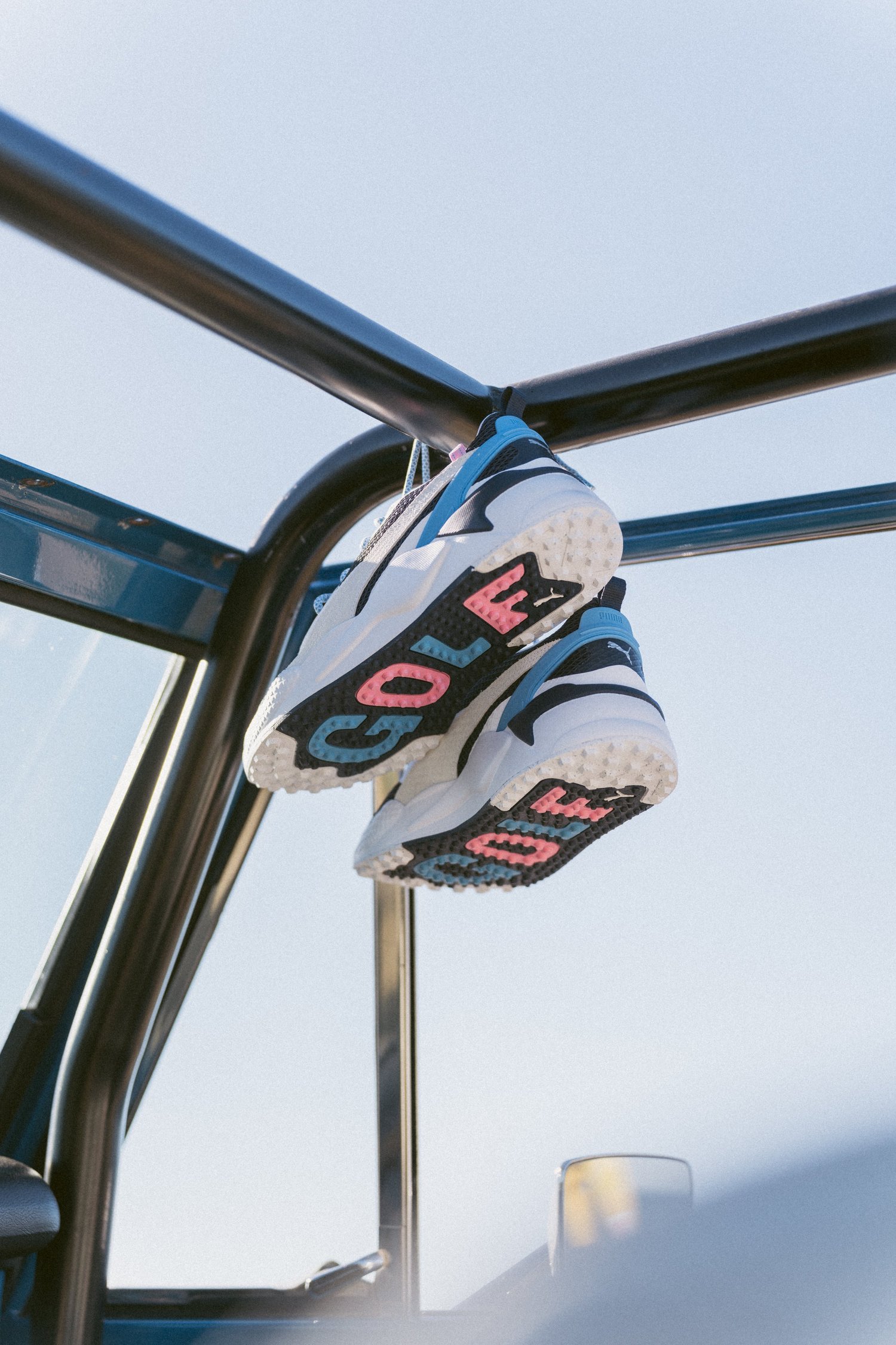 Golf shoes hung in the cage